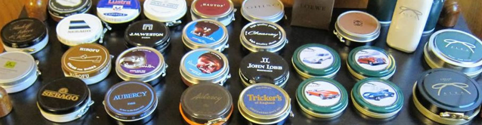 An array of colorful shoe polish tins lined up, hinting at the variety of waxes and polishes discussed in the blog.